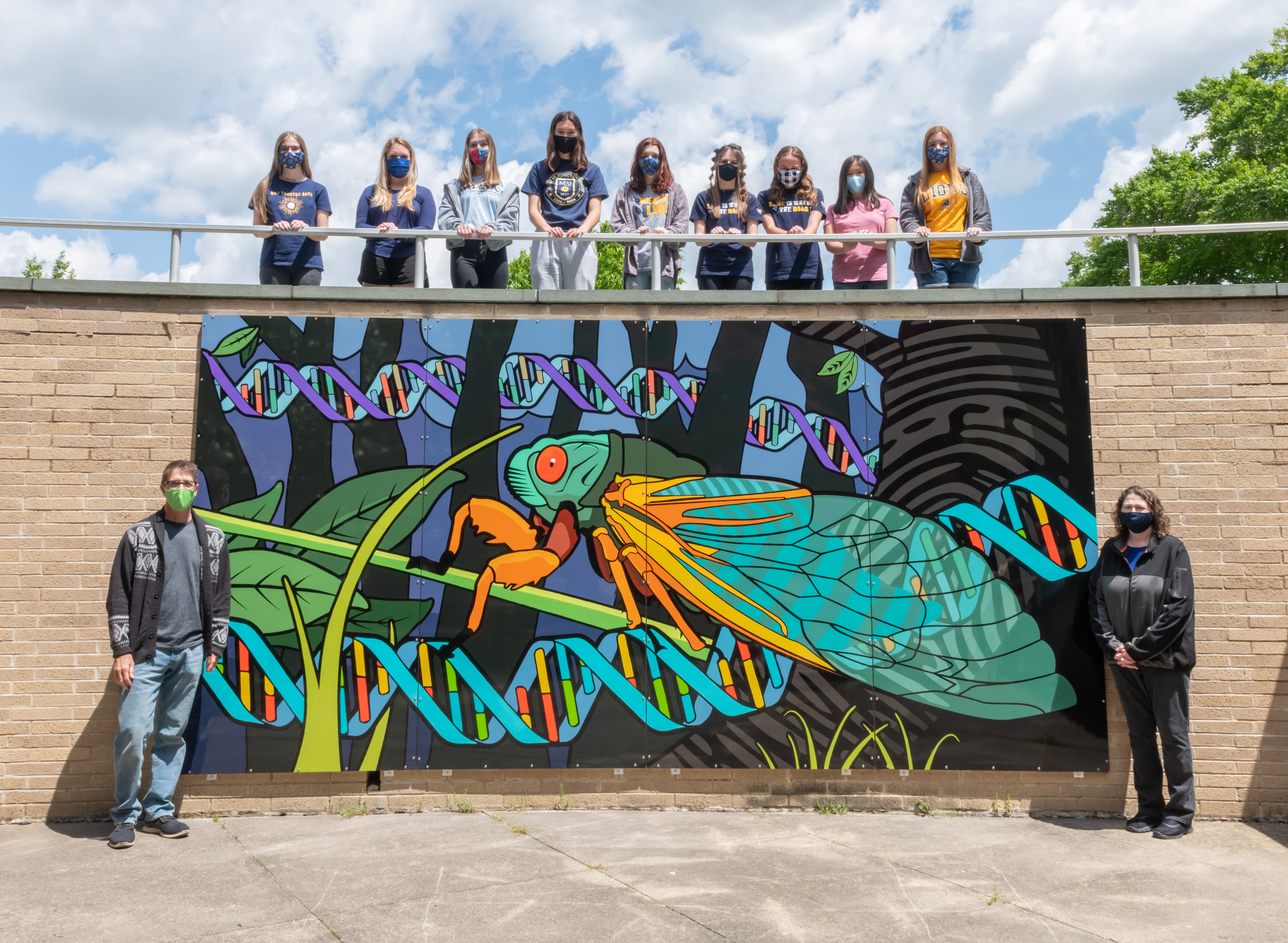 Cicada Mural MSJ Art Guild students standing in front of Cicada Mural.